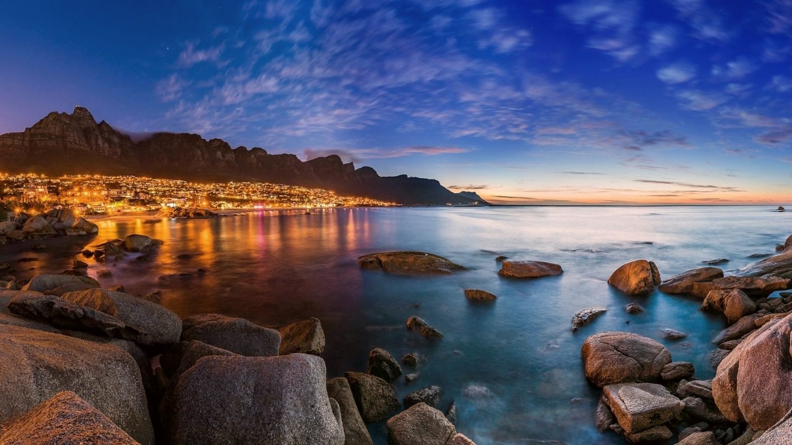Camps Bay and the Twelve Apostles above the Atlantic coast, Cape Town, at dusk.