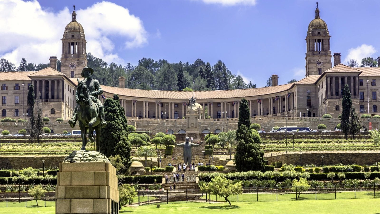 The Union Buildings in Pretoria above terraced gardens, with an equestrian statue in the foreground.